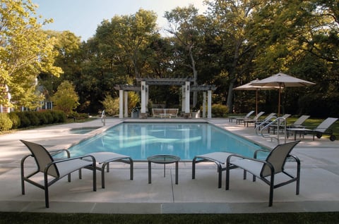 backyard pool and spa with seating area