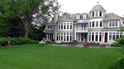 house with large yard with green grass