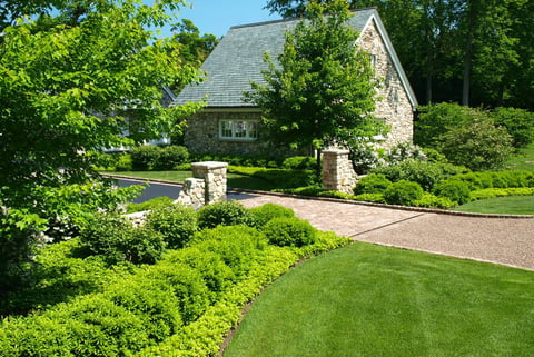 long driveway with graden beds