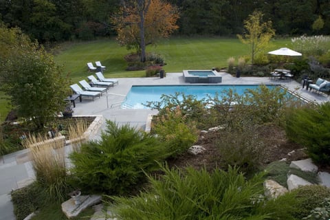 pool and spa surrounded by garden beds